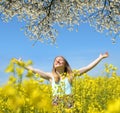 Young happy woman on blooming rapeseed field Royalty Free Stock Photo
