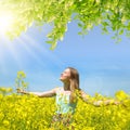 Young happy woman on blooming rapeseed field Royalty Free Stock Photo