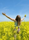 Young happy woman on blooming rapeseed field Royalty Free Stock Photo