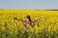 The Young happy woman on blooming rapeseed field in spring Royalty Free Stock Photo