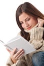 Young happy woman with book wearing turtleneck