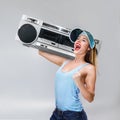 Young happy woman with boombox