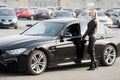 Young happy woman bought new modern car. Royalty Free Stock Photo