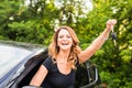 Young happy woman in the car with keys in hand - concept of buying car. Royalty Free Stock Photo