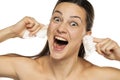 Young happy woman cleans her ears with wet wipes on a white background Royalty Free Stock Photo