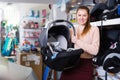 Consumer with infant`s car cradle Royalty Free Stock Photo