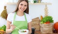 Young happy woman cooking in the kitchen. Healthy meal, lifestyle and culinary concepts. Good morning begins with fresh Royalty Free Stock Photo