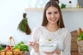 Young happy woman cooking in the kitchen. Healthy meal, lifestyle and culinary concepts. Good morning begins with fresh Royalty Free Stock Photo