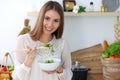 Young happy woman cooking in the kitchen. Healthy meal, lifestyle and culinary concepts. Good morning begins with fresh Royalty Free Stock Photo