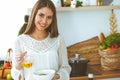 Young happy woman cooking in the kitchen. Healthy meal, lifestyle and culinary concepts. Good morning begins with fresh Royalty Free Stock Photo