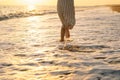 Young happy woman dancing turning around by sea in a yellow fluttering dress. Royalty Free Stock Photo