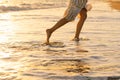 Young happy woman dancing turning around by sea in a yellow fluttering dress. Royalty Free Stock Photo