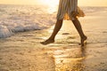 Young happy woman dancing turning around by sea in a yellow fluttering dress. Royalty Free Stock Photo