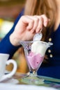 Young happy woman eating ice cream in cafe Royalty Free Stock Photo