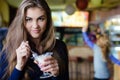 Young happy woman eating ice cream in cafe Royalty Free Stock Photo