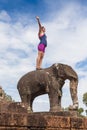 Young happy woman on elephant in the Angkor Wat temple. Royalty Free Stock Photo