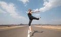 Young happy woman on an empty road in Oman desert. Royalty Free Stock Photo