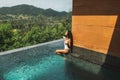 Young happy woman enjoying, splashing water and having fun in private pool Royalty Free Stock Photo