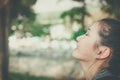 Young happy woman face smile with gum in nature take a deep breath feeling fresh. gums receding problem, oral dental care concept. Royalty Free Stock Photo