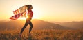 Happy woman with flag of united states enjoying the sunset on na Royalty Free Stock Photo