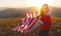 Happy woman with flag of united states enjoying the sunset on na Royalty Free Stock Photo