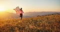 Happy woman with flag of united states enjoying the sunset on na Royalty Free Stock Photo