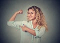 Young happy woman flexing muscles showing her strength Royalty Free Stock Photo