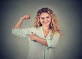 Young happy woman flexing muscles showing her strength Royalty Free Stock Photo