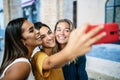 Young happy woman friends of different ethnicities having fun taking selfie Royalty Free Stock Photo