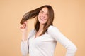 Young happy woman with healthy and natural shiny hair, isolated on studio. Beauty hair care.