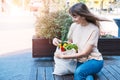 Young happy woman hold grocery tote shopping bag full of fresh vegetables. Royalty Free Stock Photo