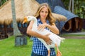 Young happy woman hold in hands funny pet - white goose Royalty Free Stock Photo