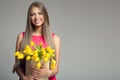 Young happy woman holding basket with yellow tulips. Royalty Free Stock Photo