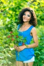 Young happy woman holding big bouquet of spring flowers outdoors Royalty Free Stock Photo