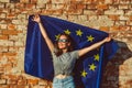 Young happy woman holding european union flag, promotion of the EU, policy concept