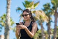 Young happy woman holding mobile phone laughing Royalty Free Stock Photo