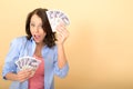 Young Happy Woman Holding Money Looking Pleased and Delighted