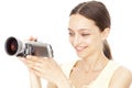 Young happy woman holding small video camera Royalty Free Stock Photo