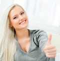 Young and happy woman holding thumbs up Royalty Free Stock Photo