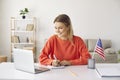 Young happy woman at home learning English attending online courses using laptop. Royalty Free Stock Photo