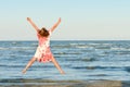 Young happy woman jumping high at seaside Royalty Free Stock Photo