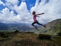 Young happy woman jumping on top of the mountain Royalty Free Stock Photo