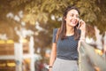 Young, happy woman listening to a cell phone call