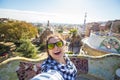 Young happy woman making selfie portrait with smartphone in Park Guell, Barcelona, Spain Royalty Free Stock Photo