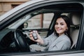 Young happy woman near the car with keys in hand. Concept of buying car Royalty Free Stock Photo