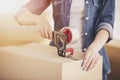 The young happy woman packing boxes. Moving, purchase of new habitation Royalty Free Stock Photo