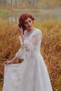 Young happy woman in a park near the river in autumn season Royalty Free Stock Photo