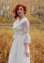 Young happy woman in a park near the river in autumn season Royalty Free Stock Photo