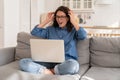 Young happy woman with raised hands looking on laptop screen with lottery victory or job offer email Royalty Free Stock Photo