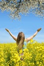 Young happy woman in the rapeseed field Royalty Free Stock Photo